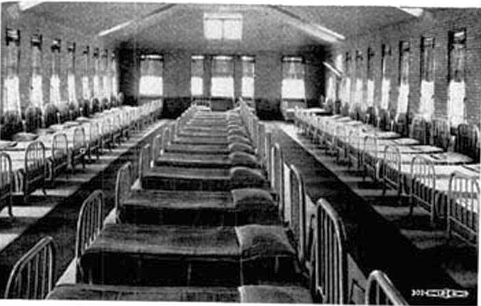 Black and white photo of an empty aslyum ward